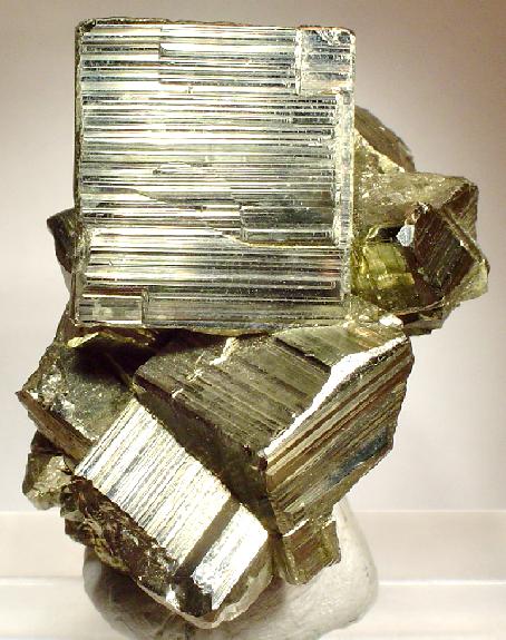 Cluster of brass-yellow pyrite cubes on matrix, from the Huanzala Mine, Peru